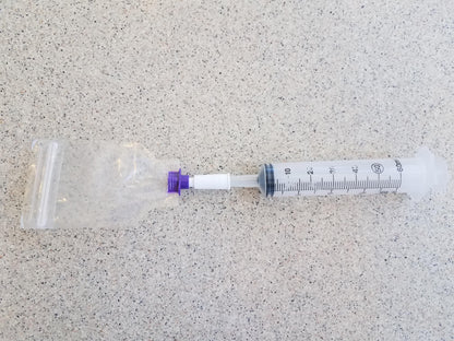 Female ENFit to Female Catheter Adapter Connected to Pill Pouch on One Side and Syringe to the Other
